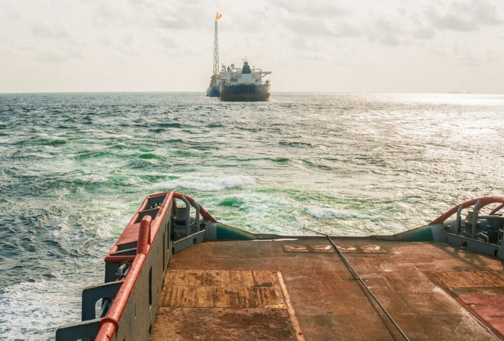 AHTS vessel doing static tow tanker lifting. Ocean tug job