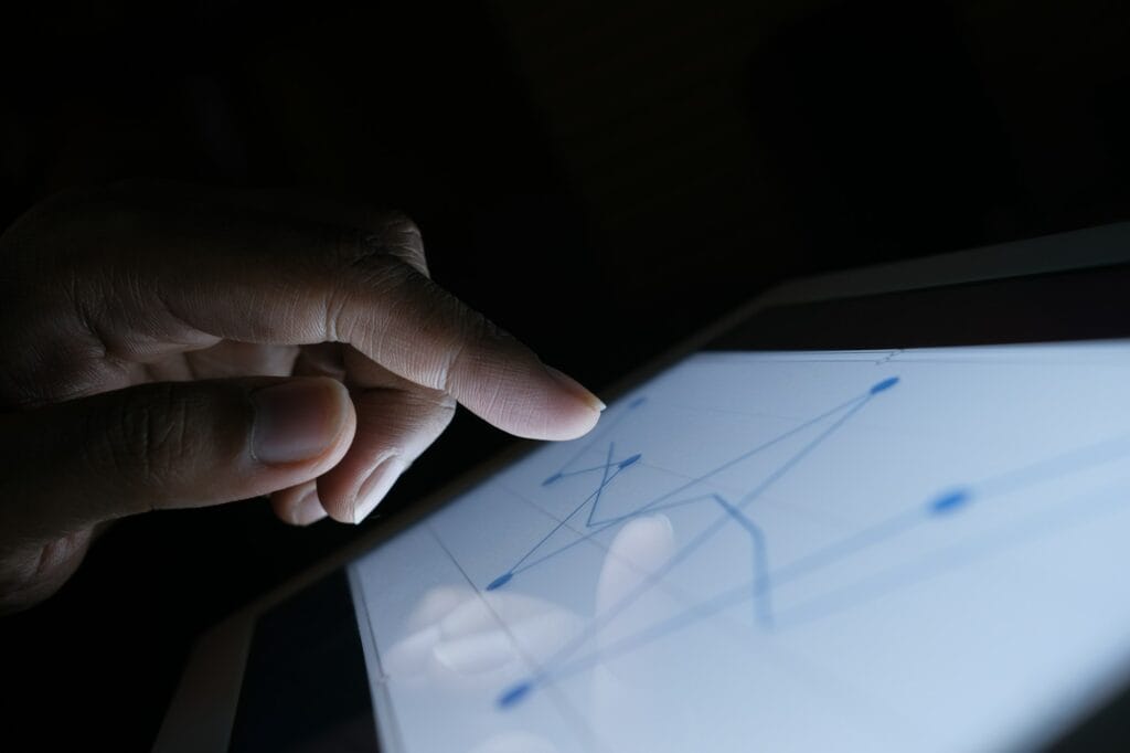 man's hand working on digital tablet on office desk
