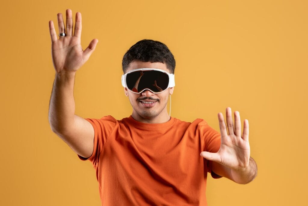Technology and entertainment concept. Happy latin man with virtual reality vision pro glasses