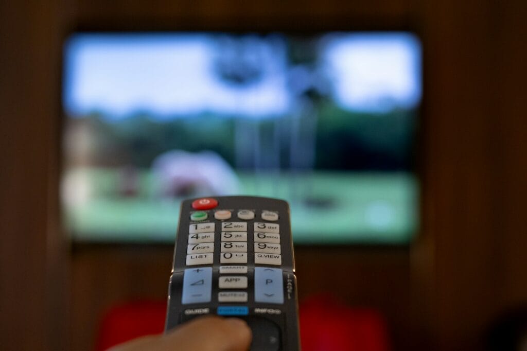 TV remote control pointing towards the TV